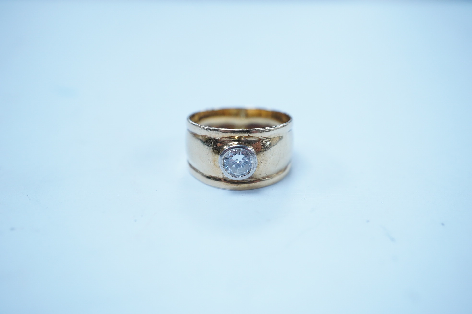 A 750 yellow metal and collet set solitaire diamond set band, stone diameter approx. 5.4mm, size L, gross weight 4 grams. Condition - fair